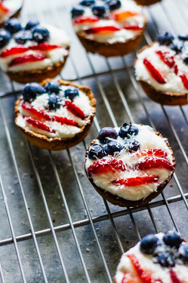 The cutest little Fruit Tarts made with blueberries and strawberries, perfect for Fourth of July! These patriotic tarts not only look the part but they taste incredible and better yet they're super healthy! #fruittarts #berrytarts Patriotic Mini Fruit Tarts side angle