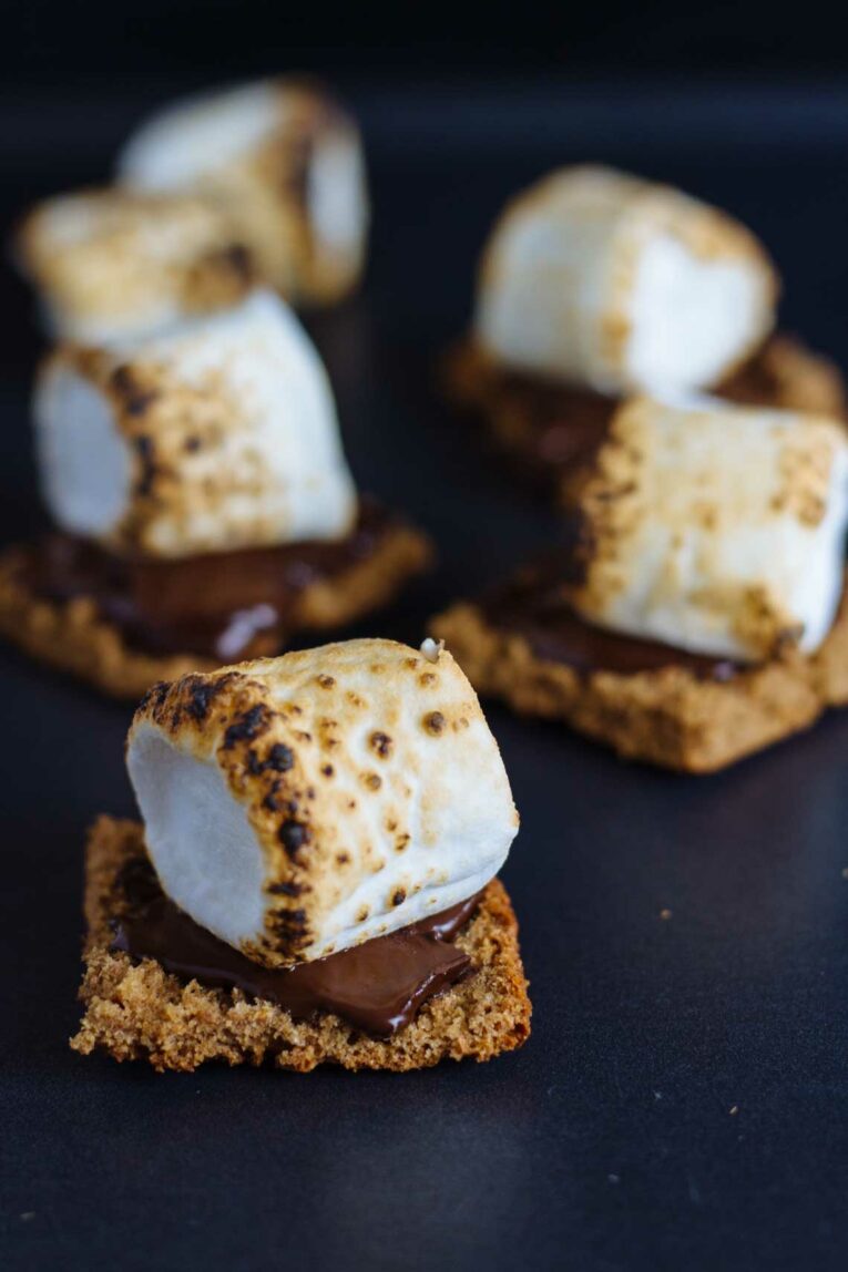Healthy s'mores made with homemade graham crackers, chocolate, and marshmallows.