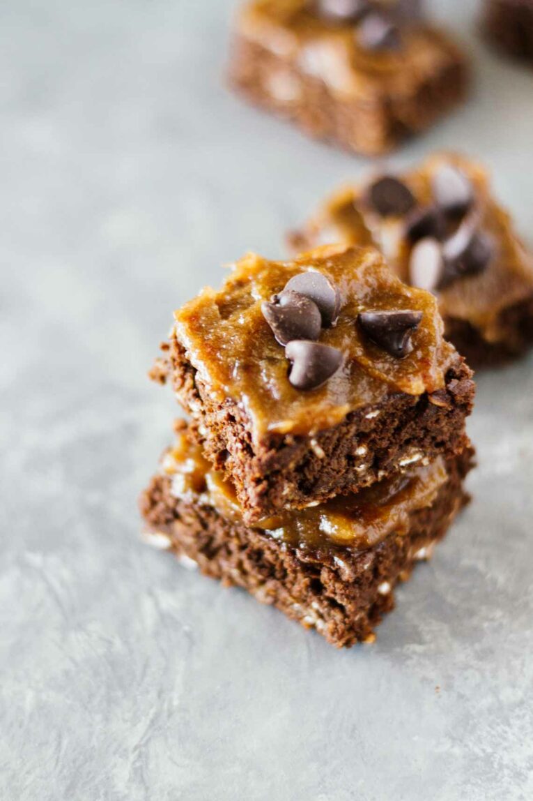 Two Healthy Chocolate Brownies w/ Date Caramel Sauce stacked on top of each other