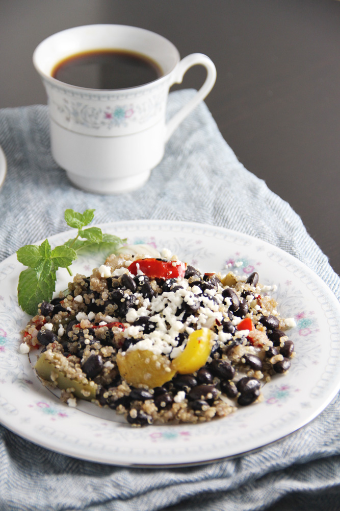 Beans and quinoa on a plate with coffee.