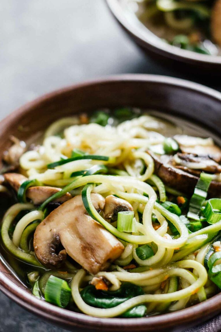 Vegan Ramen Soup w/ Zucchini Noodles, Mushrooms, and Green Onions in a Brown Bowl