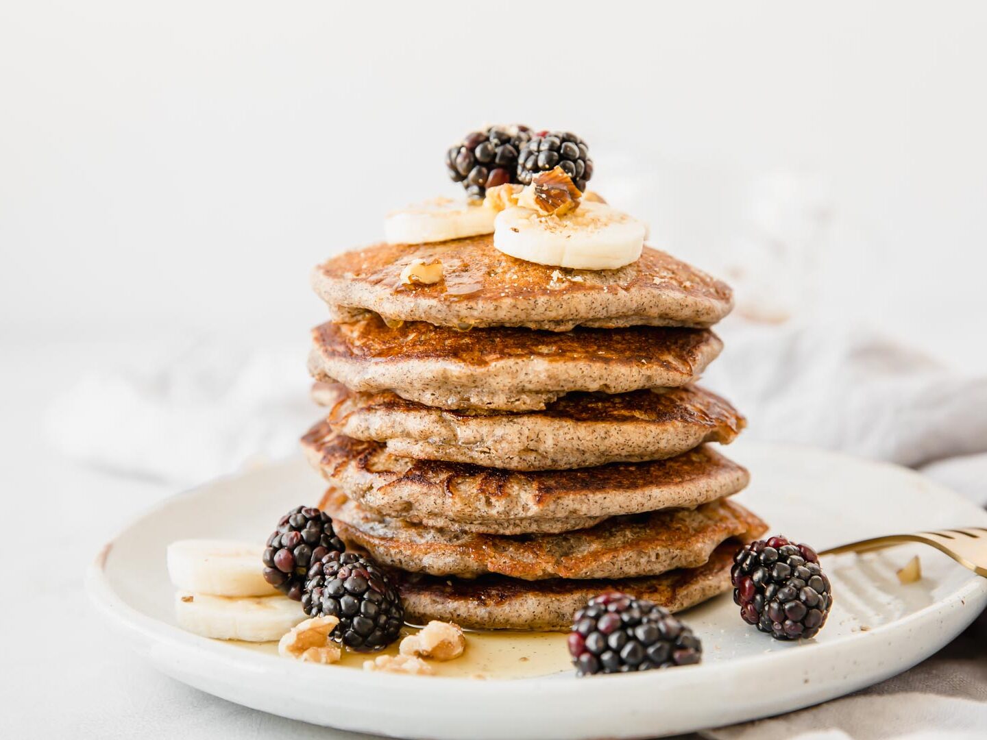 A stack of Buckwheat Pancakes on a white plate