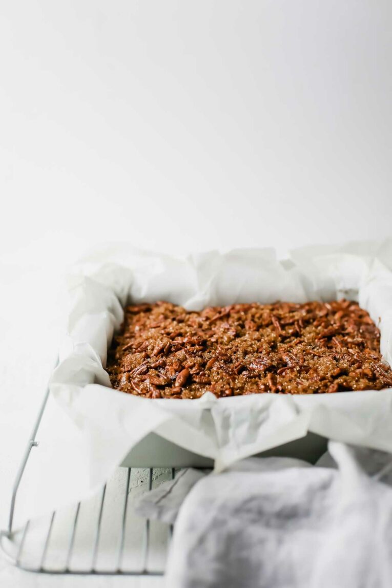 side angle of The BEST Pecan Pie Bars in a baking dish