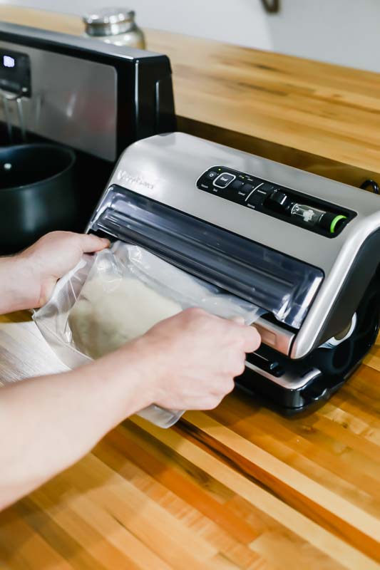hands holding bag demonstrating How to use the foodsaver