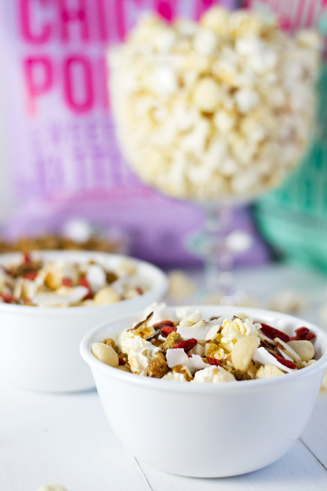 Popcorn party mix in bowls with trifle bowl in background.