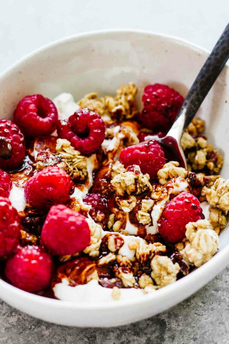 Close up shot of Raspberry Chocolate Yogurt Bowl with a spoon