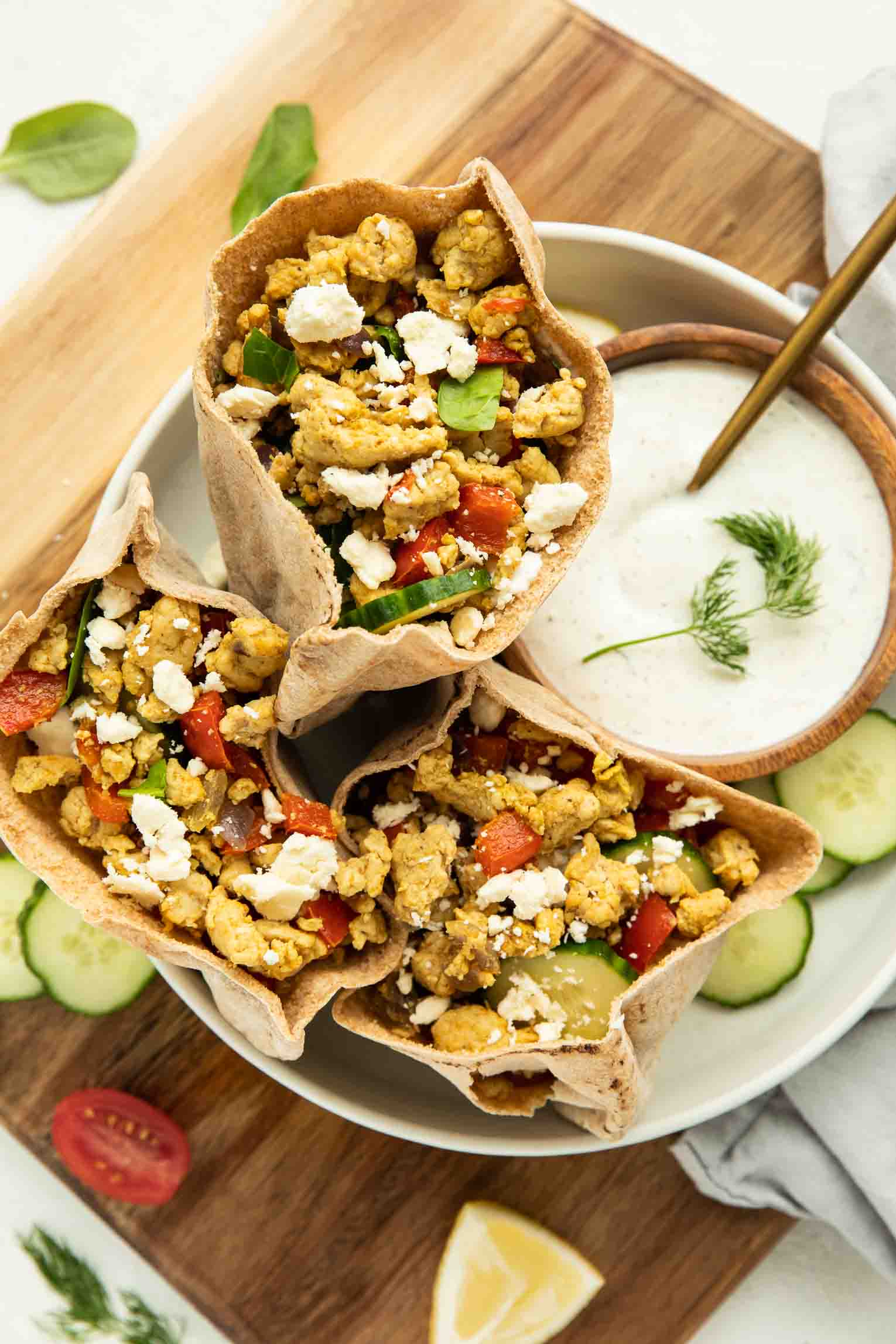  Ground Turkey Pita Pockets, stuffed with avocado and spinach artichoke dip sitting on a plate.