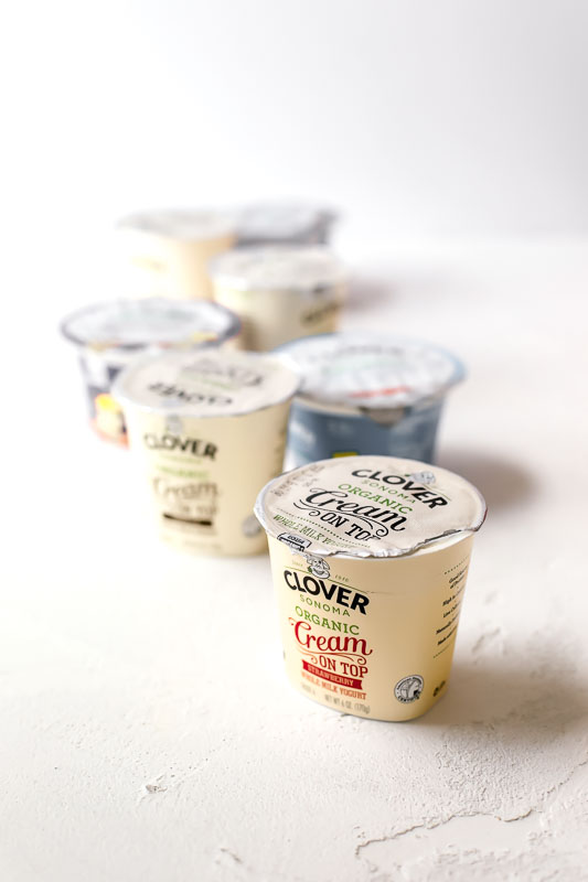 Several containers of Clover Sonoma Yogurt sitting on a counter.
