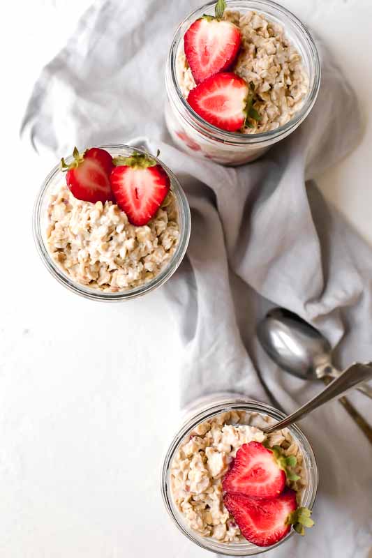 Overhead shot of Strawberries & Cream Overnight Oats in mason jars. 