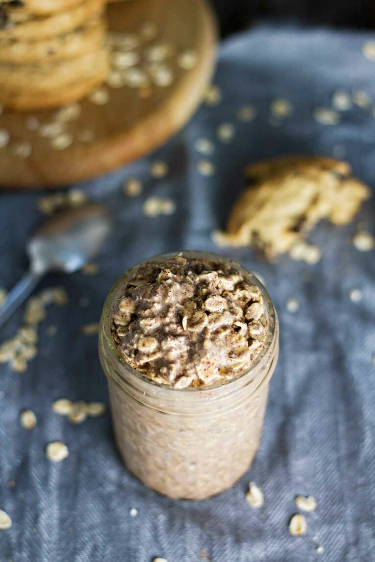 Oatmeal Cookie Overnight Oats in a mason jar on a blue dishcloth