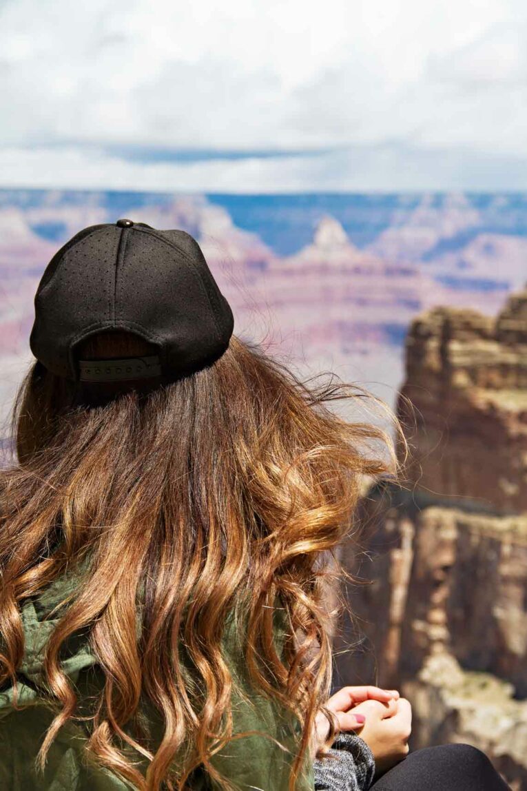 back of girls head. she's looking into the Grand Canyon