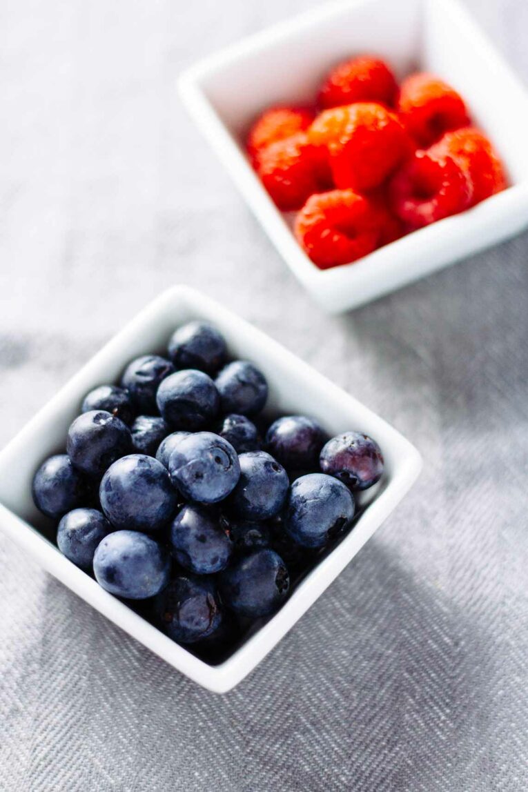 Berries in ramekins used to top overnight oats