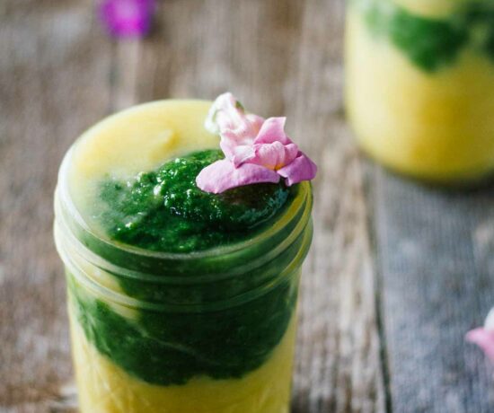 Kiwi smoothie in a mason jar with pineapple, turmeric, and healthy ingredients.