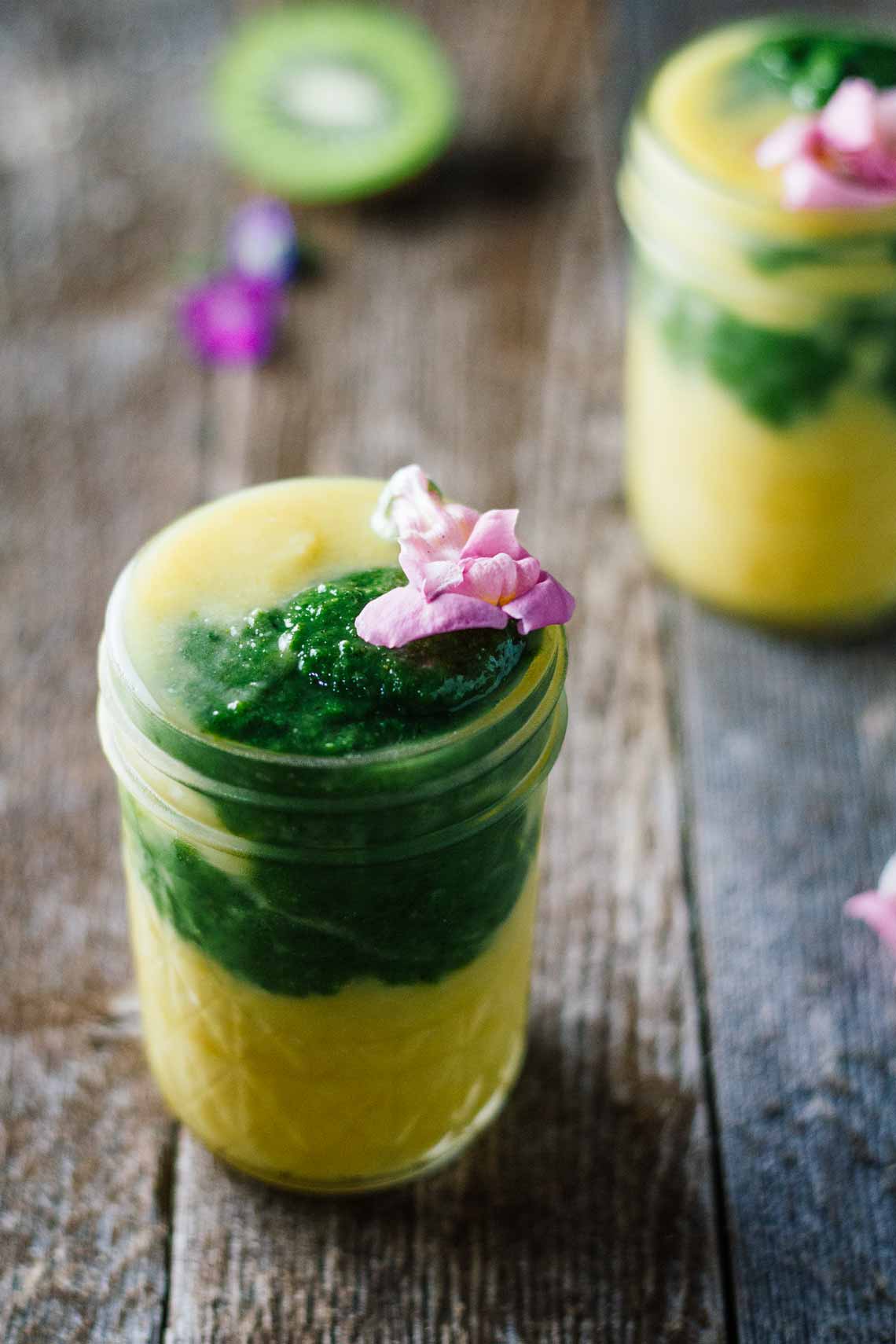 Kiwi smoothie in a mason jar with pineapple, turmeric, and healthy ingredients.