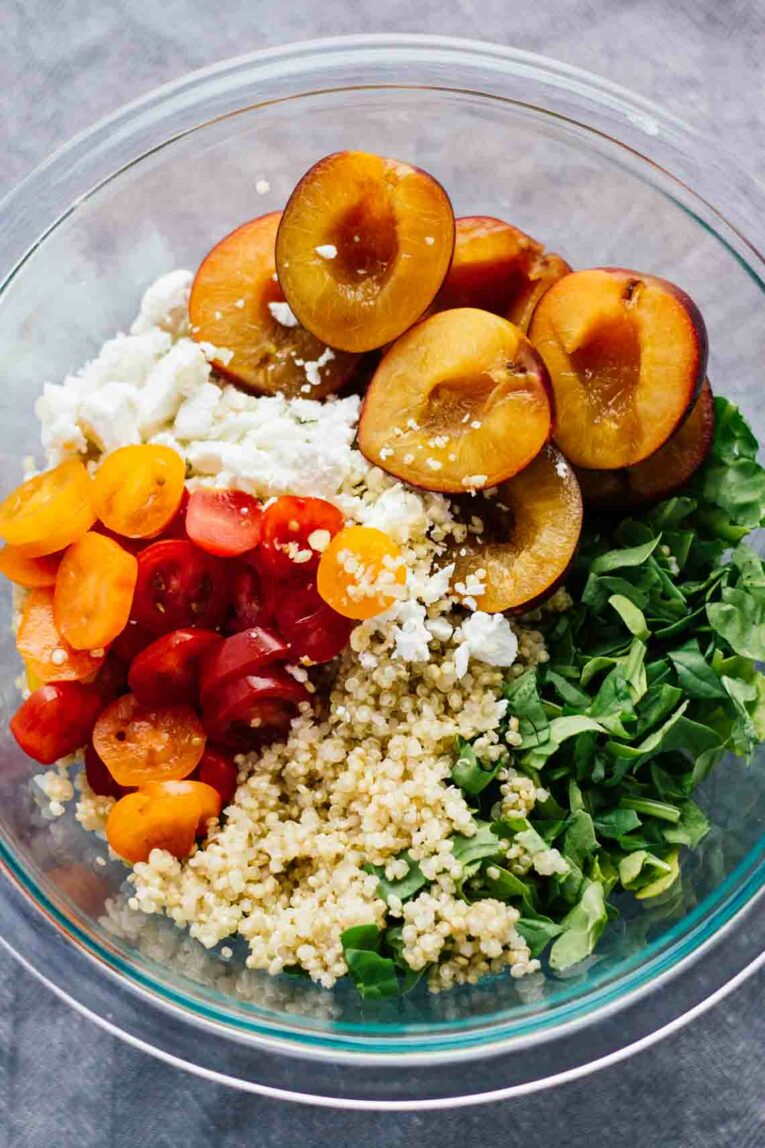 close up of Cherry Plum & Goat Cheese Summer Salad in a clear bowl