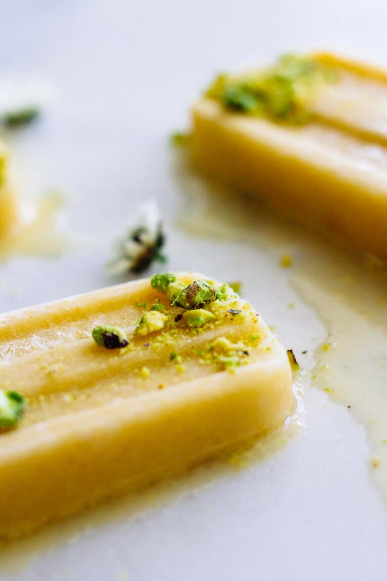 close up of slightly melted Coconut Peach Turmeric Popsicles