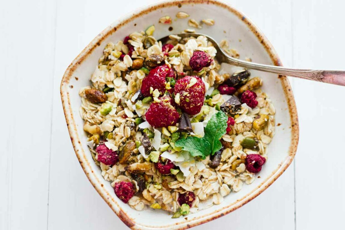 Homemade muesli in a white bowl with a spoon