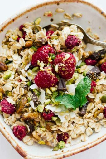 Homemade muesli in a white bowl with a spoon