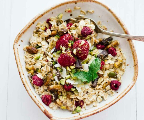 Homemade muesli in a white bowl with a spoon