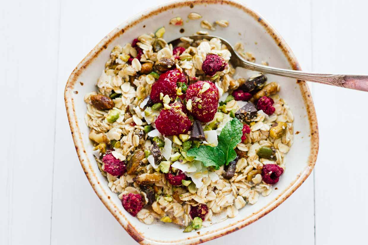 Homemade muesli in a white bowl with a spoon