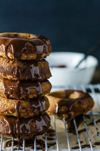 Healthy donuts stacked on top of each other topped with chocolate drizzel