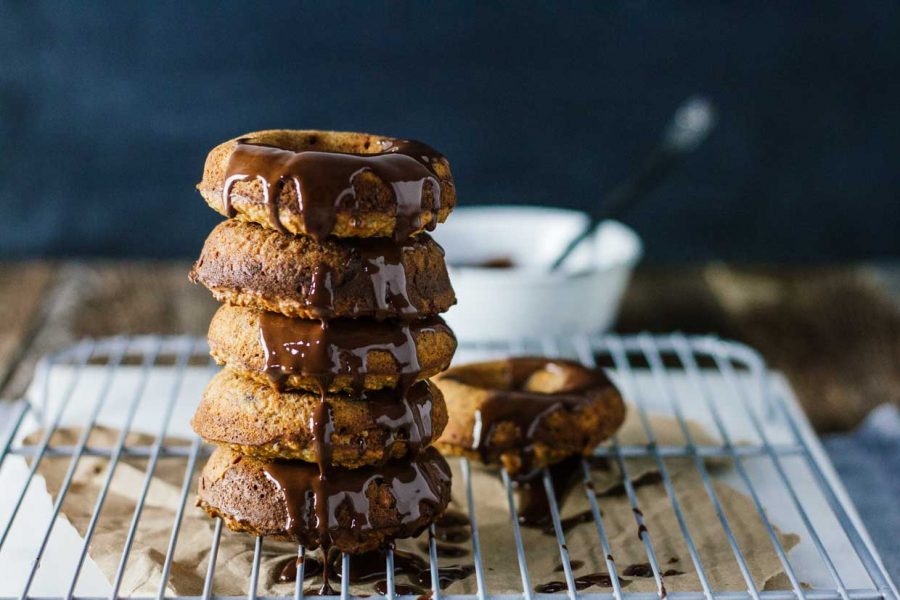 Healthy donuts stacked on top of each other topped with chocolate drizzel