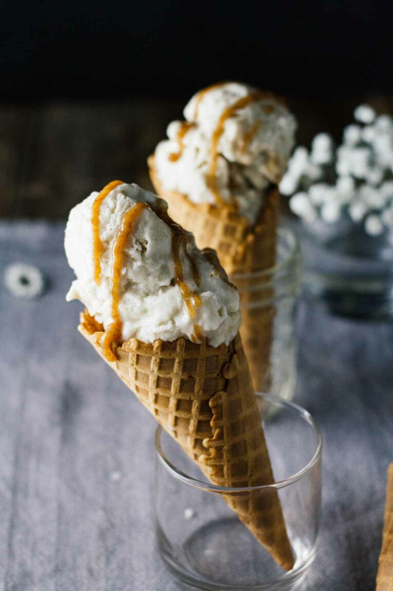 Vegan Salted Caramel & Chamomile Ice Cream in a waffle cone, standing upright in a glass