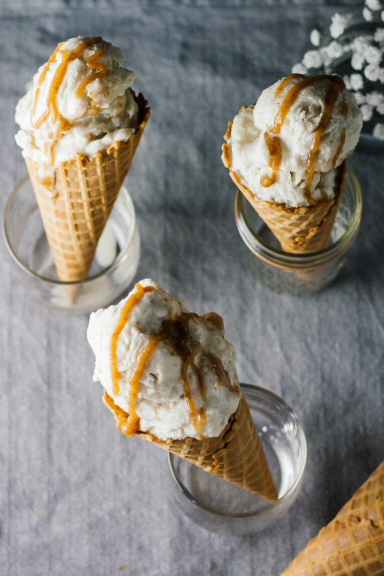 overhead view of Vegan Salted Caramel & Chamomile Ice Cream in waffle cones standing upright in glasses