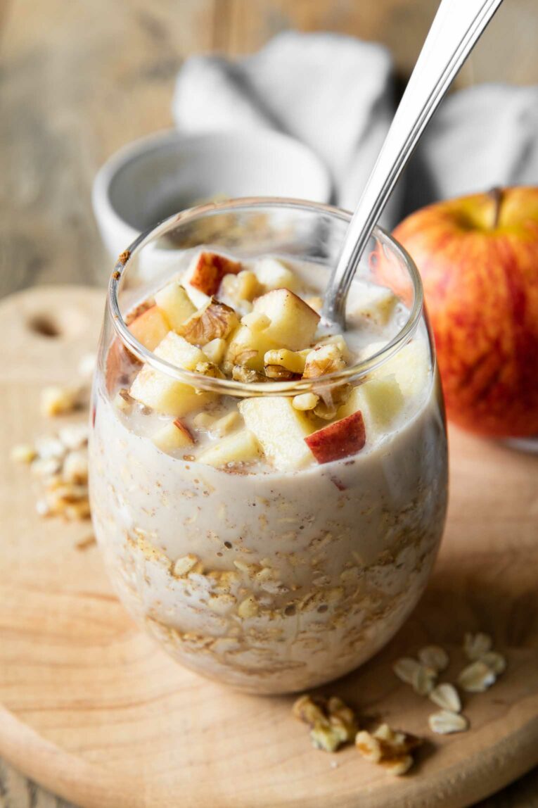 Apple Cinnamon Overnight Oats in a glass with a spoon.