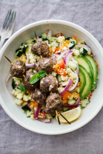 Mediterranean Salad Bowls w/ Lebanese BBQ Meatballs! This gluten-free recipe makes for an easy, healthy weeknight dinner. Also perfect for having people over!