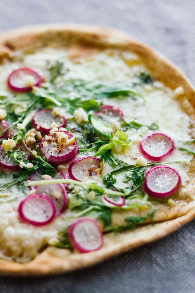 close up of Roasted Radish, Arugula, & Havarti Pita Bread Pizza