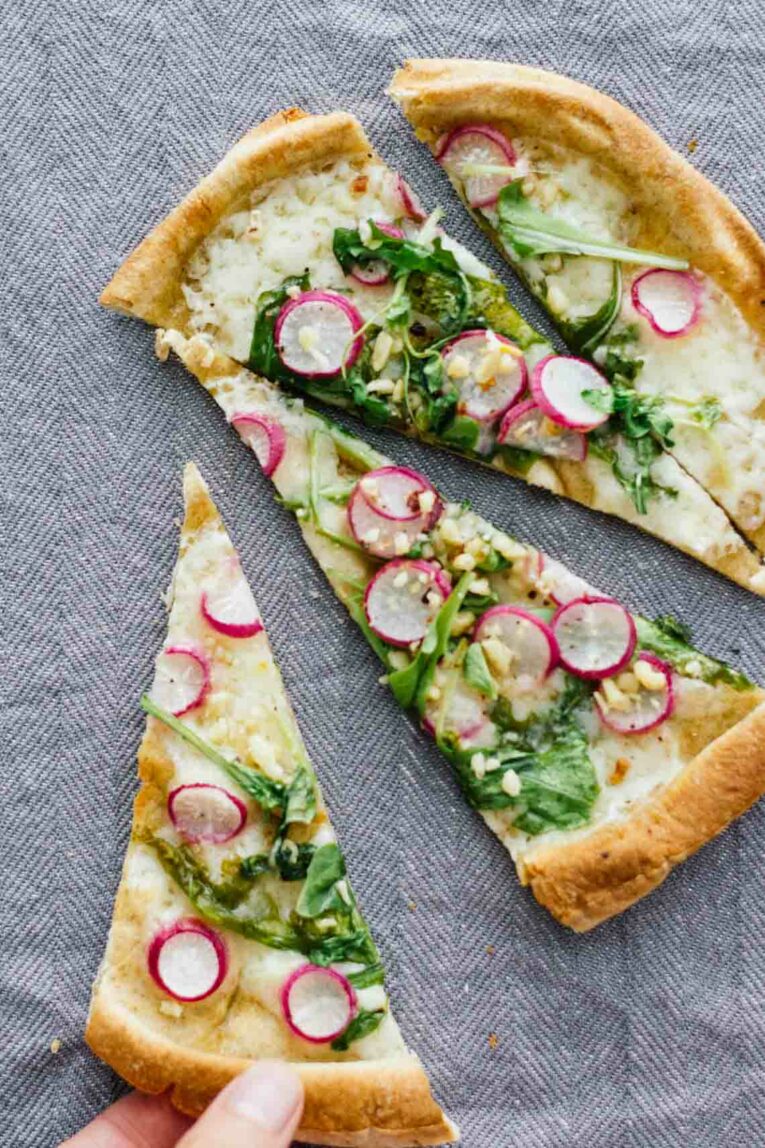 Roasted Radish, Arugula, & Havarti Pita Bread Pizza cut into slices