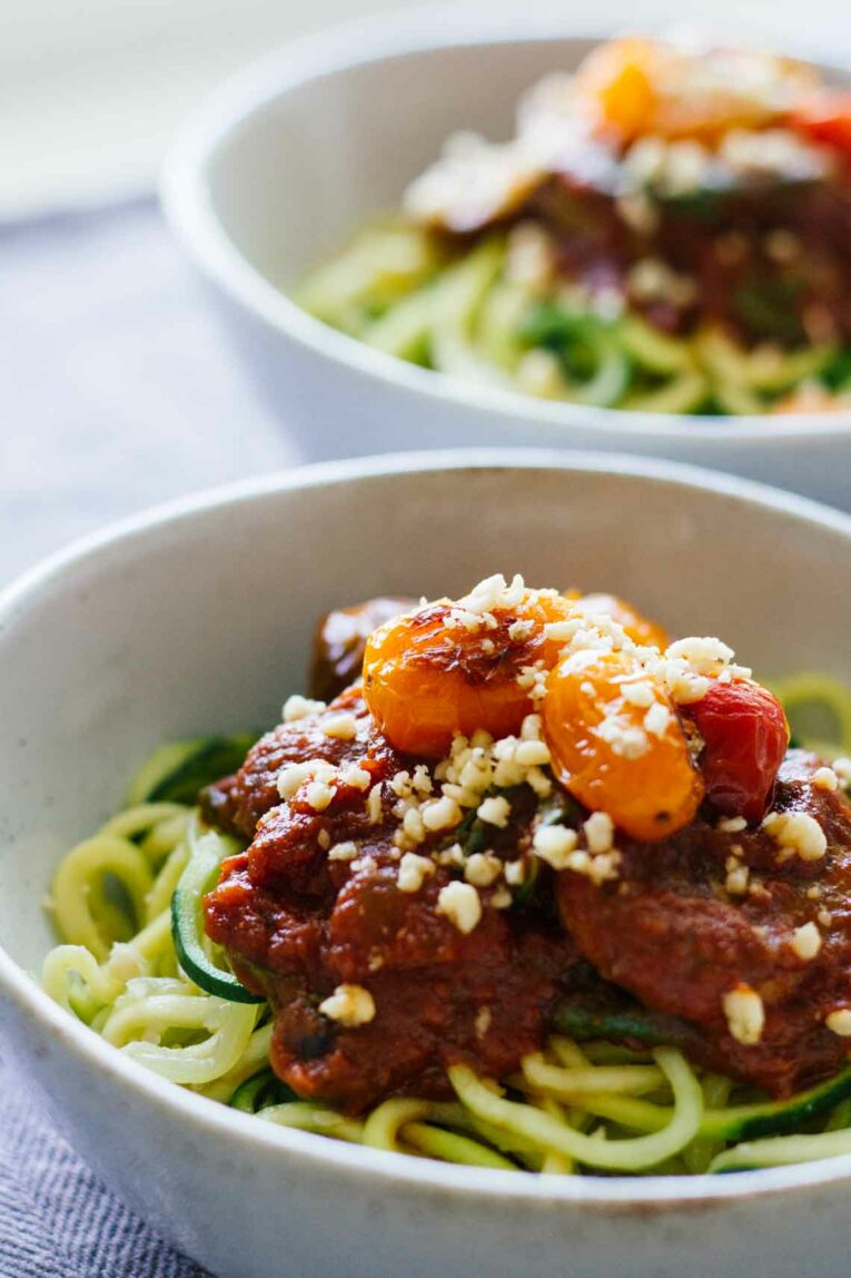 side view of Vegetarian Zucchini Spaghetti w/ Red Sauce & Mushrooms in a bowl