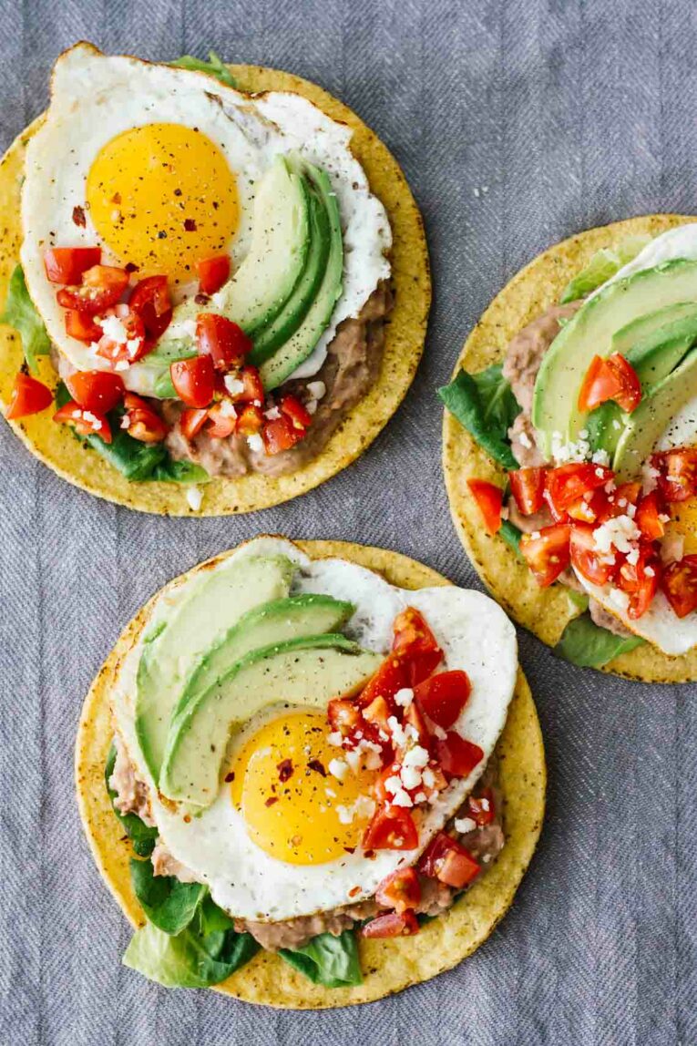 An overhead shot of Huevos Rancheros in three tostadas