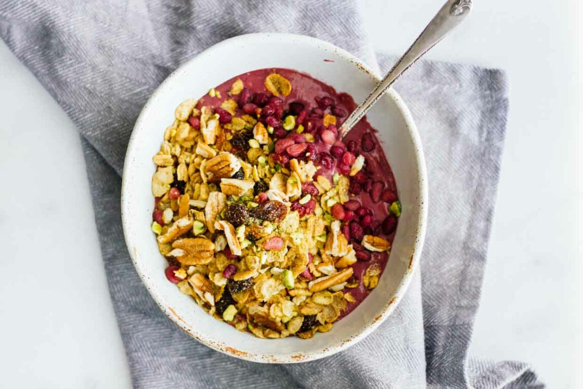 An overhead shot of an acai bowl with a spoon