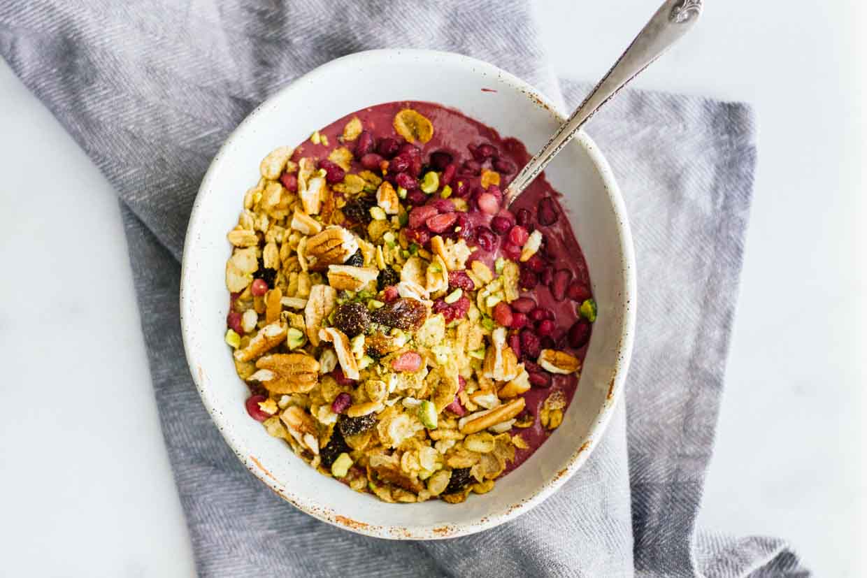 An overhead shot of an acai bowl with a spoon