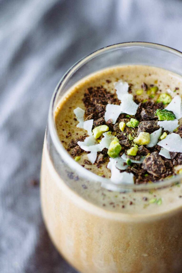 A close up of a Creamy Mocha Coffee Smoothie topped with nuts and chocolate