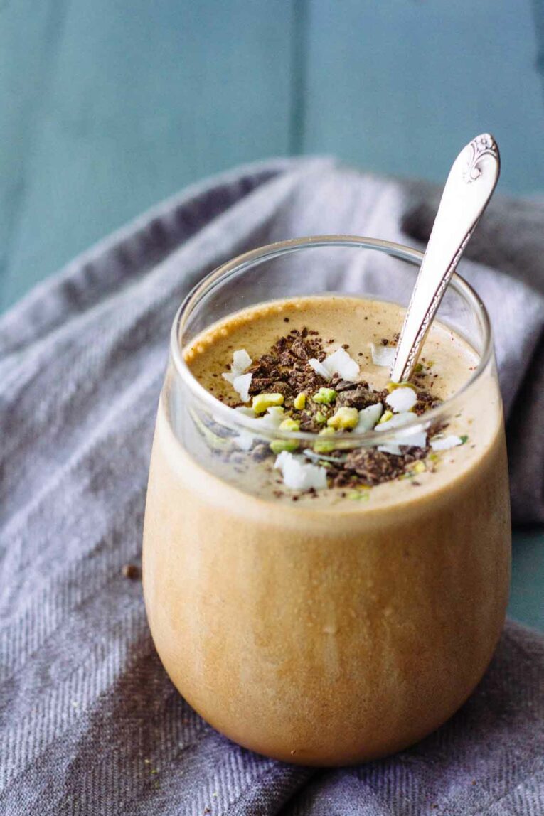 A Creamy Mocha Coffee Smoothie in a glass topped with nuts