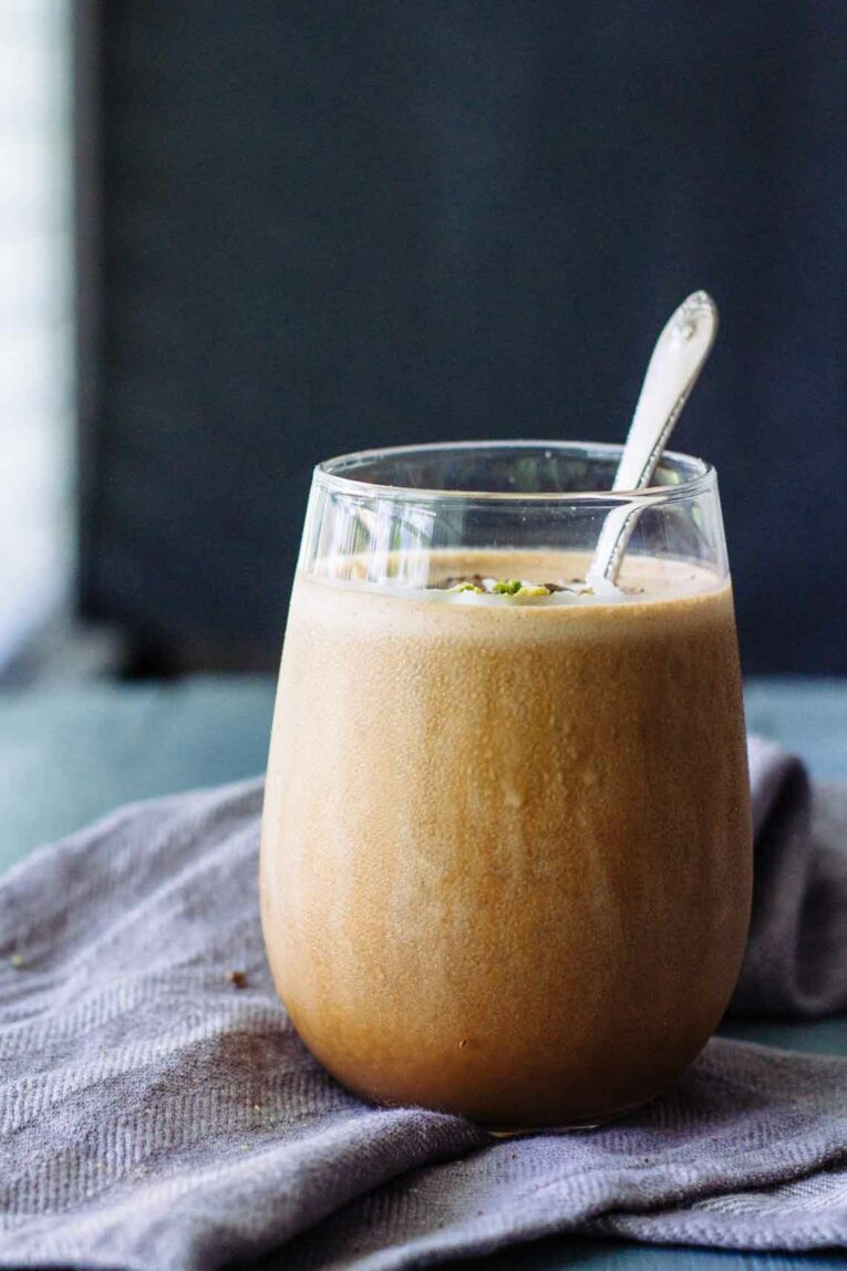 A Creamy Mocha Coffee Smoothie in a glass with a spoon