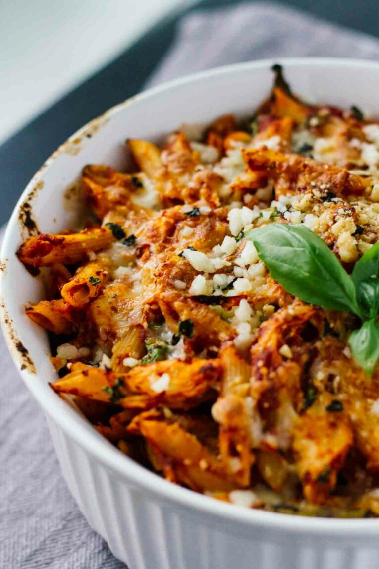 close up of One-Pot Basil Chicken Baked Ziti in a white baking dish