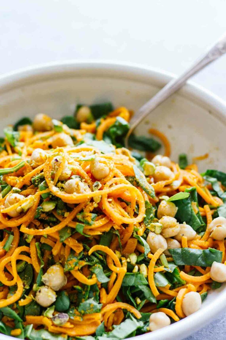 Sweet Potato Noodles with Turmeric in a Spinach and Chickpea Salad in a White Bowl
