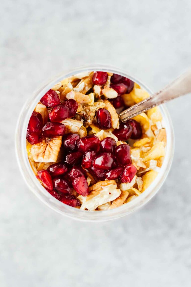 An overheads of shot of a Pomegranate Pecan Breakfast Parfait