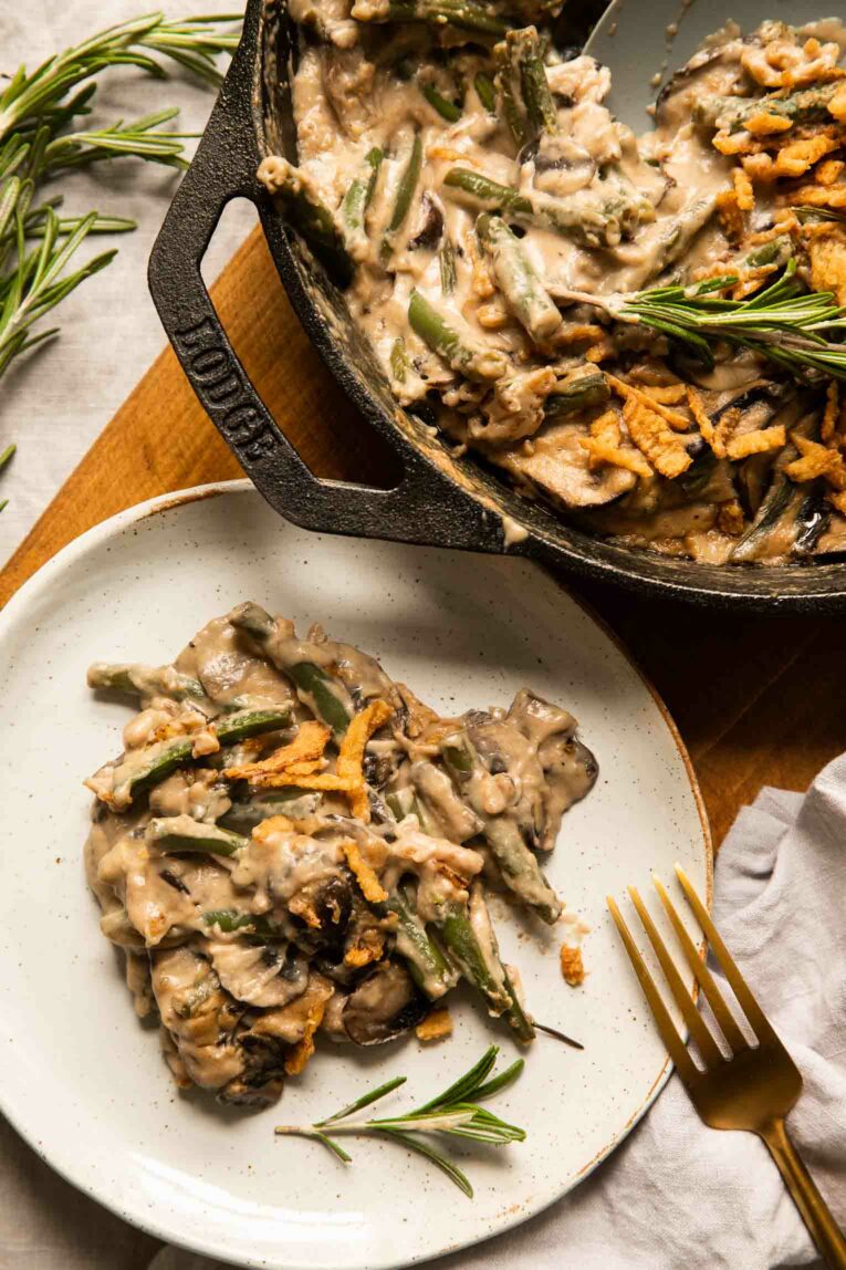 Vegan Green Bean Casserole topped with sautéed red onions and bread crumbs.