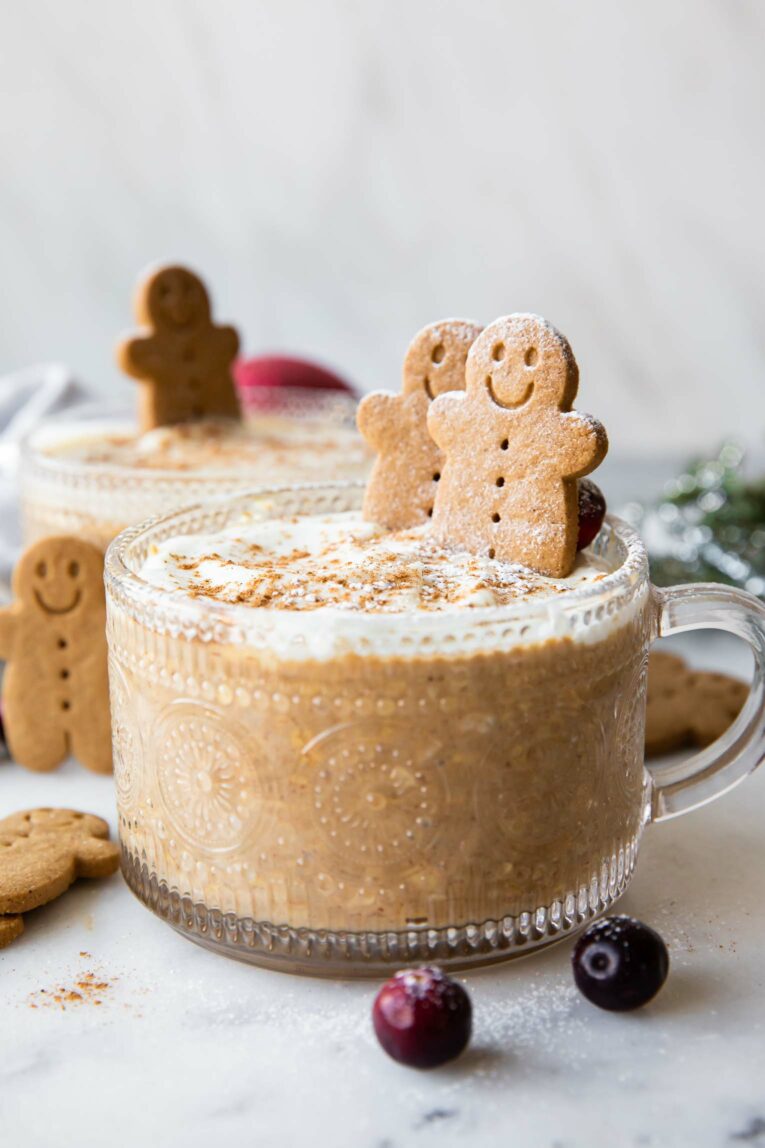 Gingerbread Cookie Overnight Oats in a mason jar topped with a gingerbread cookie.