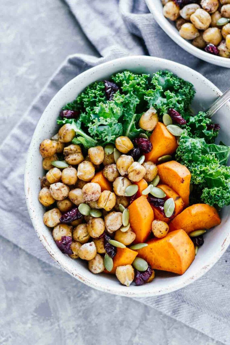 overhead shot of Vegan Winter Spiced Chickpea Power Bowl in a white bowl on a grey dishcloth