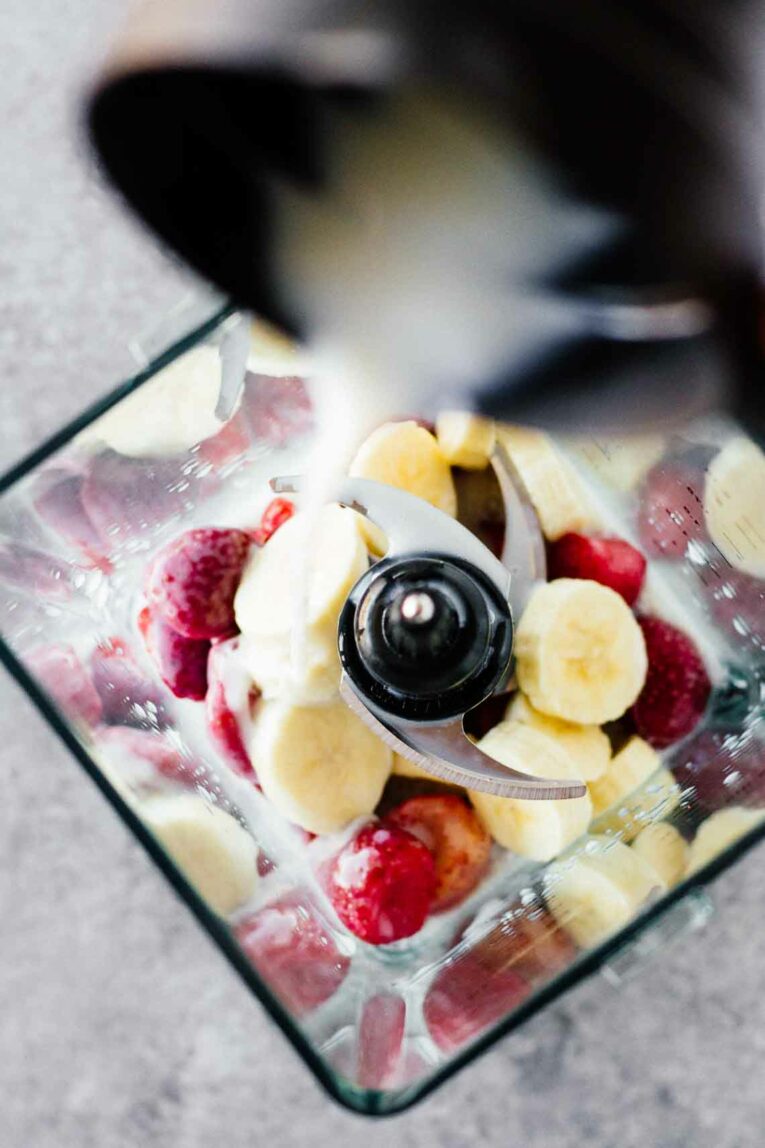Strawberries and Bananas in a blender. 