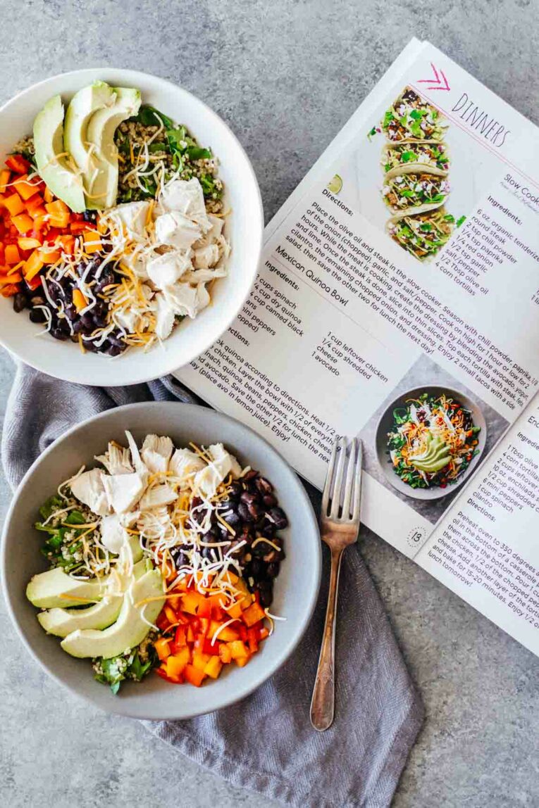 salad recipe in white bowl next to book