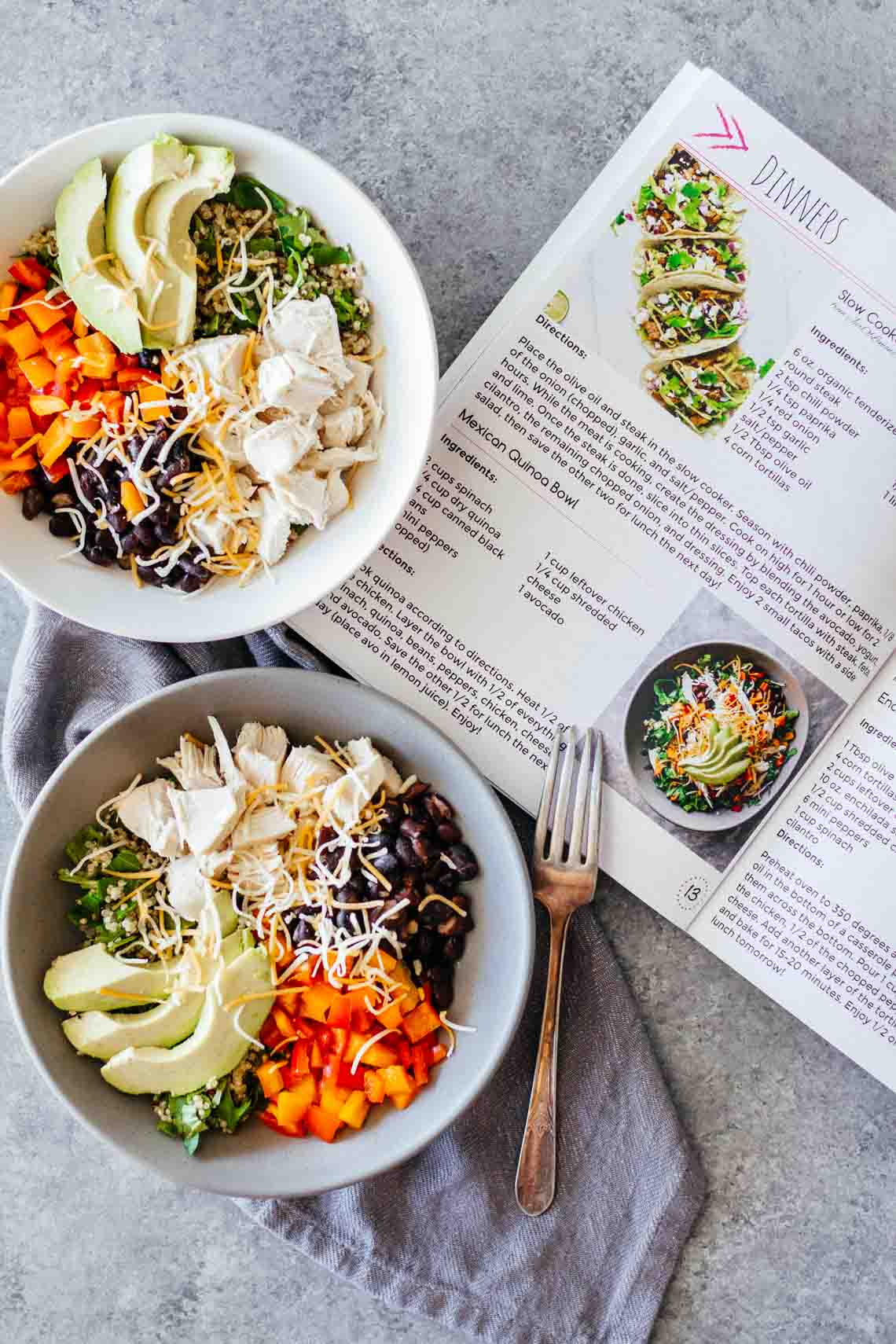 Book of A Month Of Healthy Eats For The Busy Girl! next to two bowls of healthy recipes