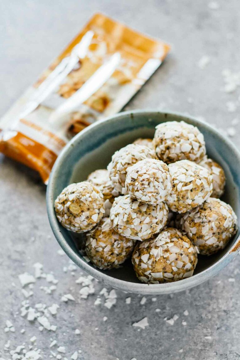 EASY Cinnamon Crunch Protein Bites! Super easy to make, 10 minutes, and loaded with protein. Delicious! #proteinbites #proteinballs A close up of a bowl of protein bites in a blue bowl
