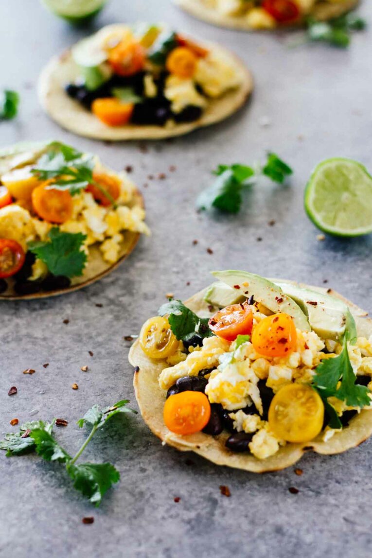 A side shot of healthy breakfast tacos on a blue work surface
